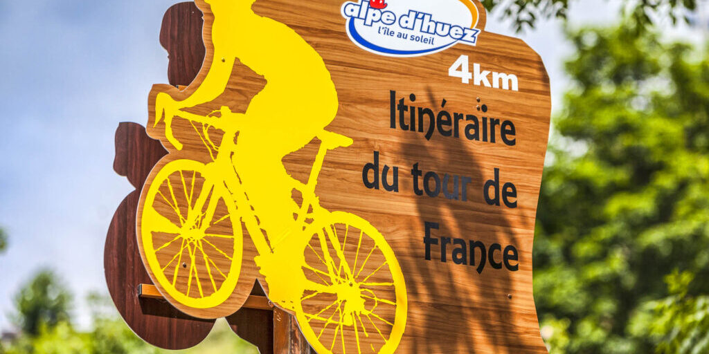 Alpe-D'Huez,France- July 18, 2013: Road indicator of the route for Tour de France located on  the road to Alpe D'Huez, in the stage 18 of the edition 100 of Le Tour de France 2013.