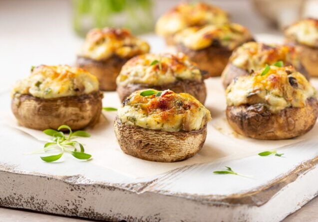 Stuffed mushrooms with cheese, delicious baked appetizer, traditional starter, golden crust