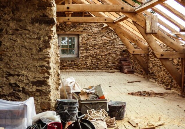 Old typical stone wall house undergoing a roof renovation - French countryside